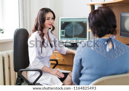 The young joyful breast specialist talking with the patient in her office Royalty-Free Stock Photo #1164825493