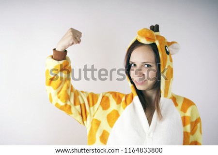 girl in a bright children's pajamas in the form of a kangaroo. emotional portrait of a student. costume presentation of children's animator. Slippers in the form of cat's paws.         