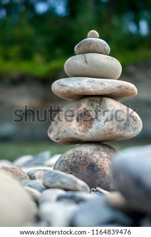 Stone cairn tower, pose stones, rock zen sculpture.