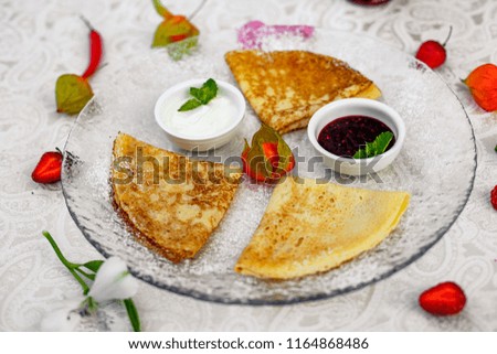 pancakes with powdered sugar berries and jam for breakfast
