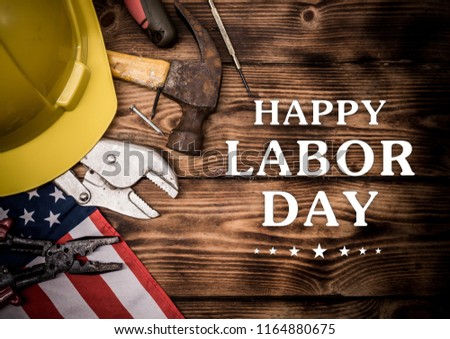 Happy Labor day. Construction tools.  Text on wood background.