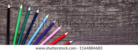 Color pencils on a circle over wooden background with copy space, Nobody. Back to school
