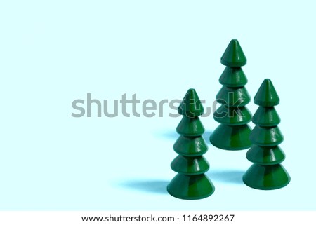 Small wooden Christmas tree on pastel blue background. Minimal style, primitivism. Christmas and New Year concept
