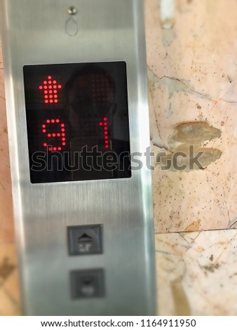 Elevator or lift numeric indicator at 9th floor with low light supply illustrated numbers and Braille signs language