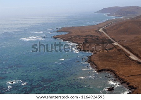 An aerial shot of the highway along the California coast line
