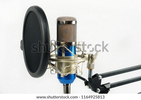 Close up shots of blue condenser microphone isolated with white background.