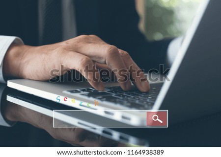 Browsing internet data networking concept. Business man working on laptop computer searching information on web browser or search engine in modern office. Close up