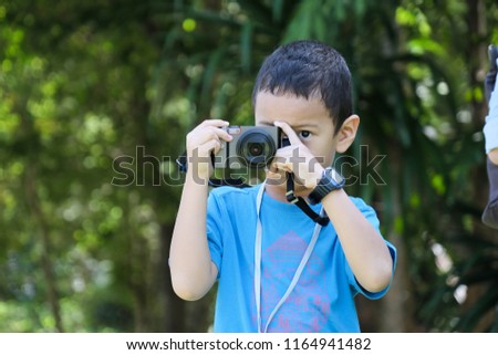 Boy take picture by compact camera