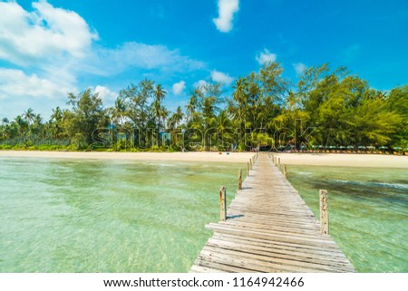 Wooden pier or bridge with tropical beach and sea in paradise island for travel and vacation