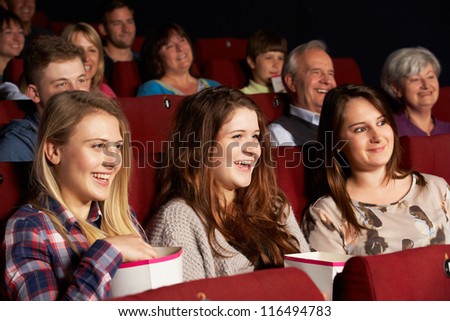 Group Of Teenage Girls Watching Film In Cinema Royalty-Free Stock Photo #116494783