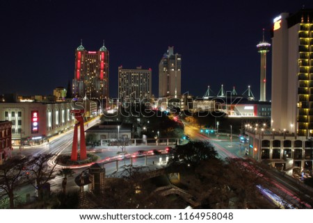 Downtown skyline view of San Antonio, TX, USA with light trails from the passing cars at street level