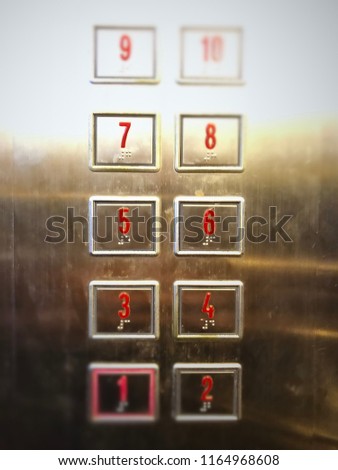 Elevator or lift numeric indicator at 7th floor with low light supply illustrated numbers and Braille signs language