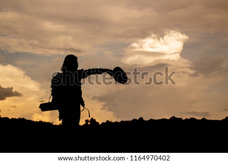 Young woman watching and Take a photo landscape,
backpacker.