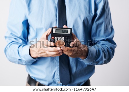 calculators and coin e-currency mens hands                              