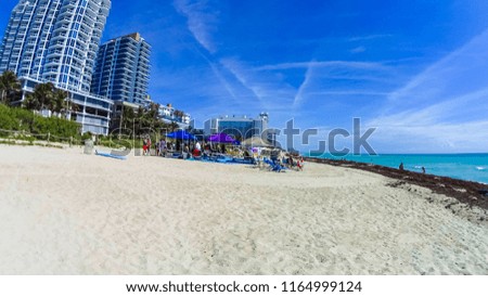 Miami Beach in Florida with luxury apartments and green grass near waterway