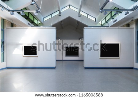 blank frames fro painting or photography on exhibition wall in a room