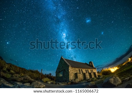 This was taken in Lake Tekapo, New Zealand. One can see milky way, galaxies, and stars in the night sky. The place is famous and popular among tourist, travelers and holiday makers. Royalty-Free Stock Photo #1165006672