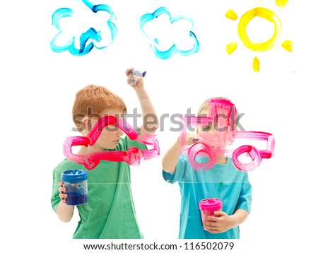 Boys painting art pictures on glass. Isolated on white.