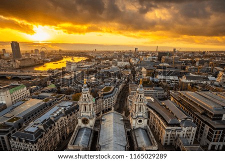 London, England - Aerial panoramic skyline view of London taken from top of St.Paul's Cathedral at sunset with beautiful golden sky and clouds