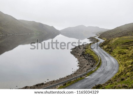 This is a picture of a curving mountain lake road in the morning mist.  This lake is called Lake Salt and is located in Donegal Ireland