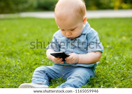 kid looks at the phone