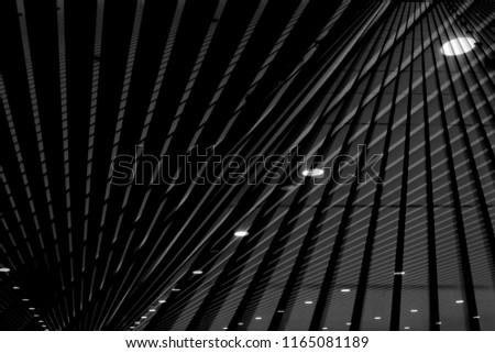 Double exposure photo of lath ceiling with spot lights. Abstract modern architecture or interior background in black and white with geometric structure.