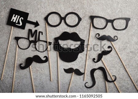 funny faces formed from black photo boots, mustache and glasses on a stone background. concept of holiday father day. top view