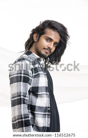 Indian handsome young man with long hair  on white background.