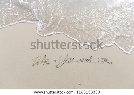 The text We and me written on the sand beach by the sea, Use it as a message is sent