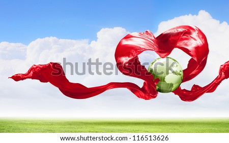 World within the heart symbol on blue sky background