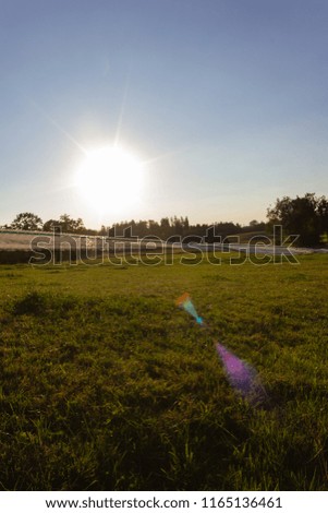 pasture fence at paddock in summer south germany evening with beams of sunset