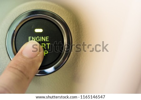 Man finger on pushing a start ignition button switch in the modern luxury car