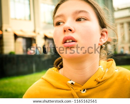 Smiling brunette teen girl close-up portrait outdoors