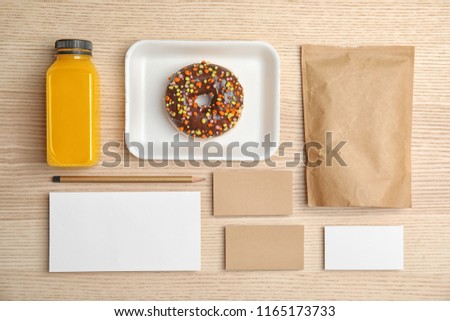 Flat lay composition with items for mock up design on wooden background. Food delivery service