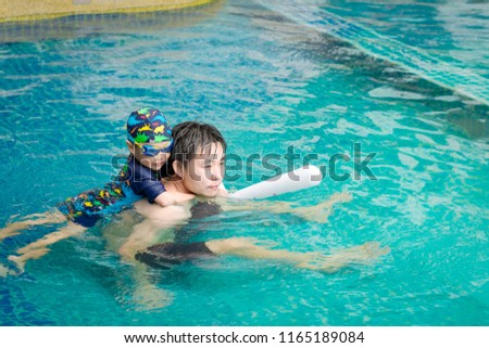 Little boy learning to swim with his father. Background. Selective focus. Copy space.