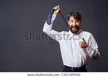 the man lifted his tie and thumb                               