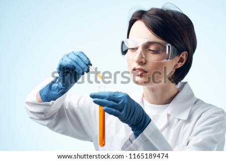 woman with bulb pipette orange liquid                       