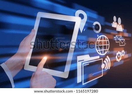Hands of businessman touching tablet screen over dark blue background with business icons and immersive interface. Hi tech concept. Toned image double exposure