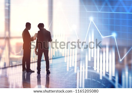 Two businessmen silhouettes talking in a panoramic office. Blue graph interface foreground with infographics and data representation. Hud. Toned image double exposure
