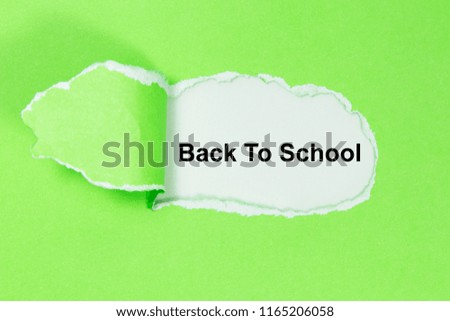 The word Back To School appearing behind torn paper