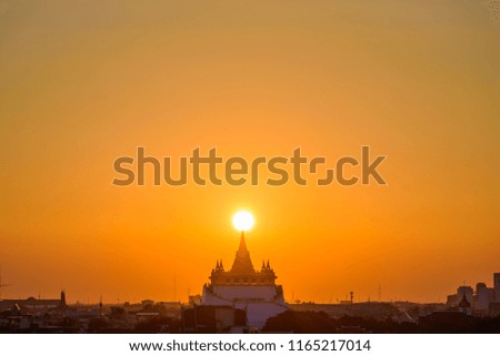 silhouette picture sunset over pagoda with orange sky background