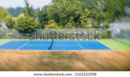Outdoor tennis court inside a public city park.