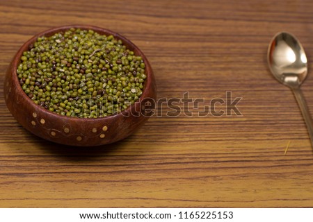 indian seeds green bean isolated on wood background