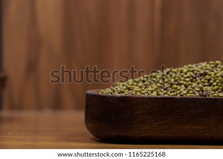 indian seeds green bean isolated on wood background