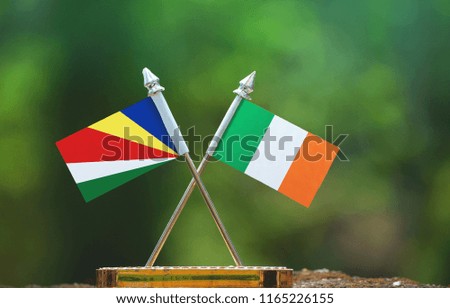 Ireland and Seychelles small flag with blur green background