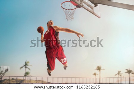 Streetball. Basketball player in action on sunset. Basketball players play in streetbol.