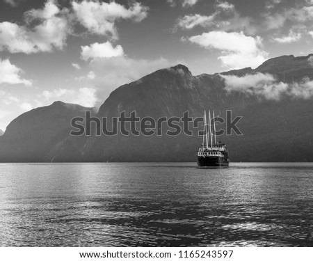 Boat on Doubtful sound New Zealand pictured against mountains