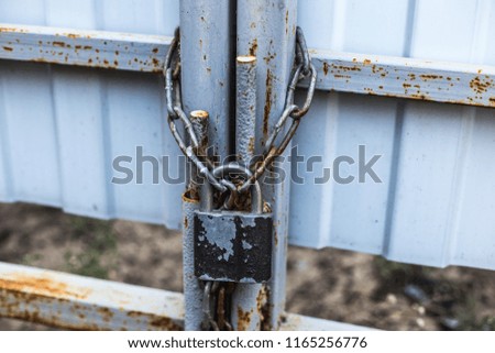 Old padlock and chain on the gate.