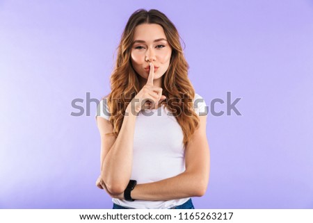 Photo of woman isolated over purple wall background showing silence gesture.