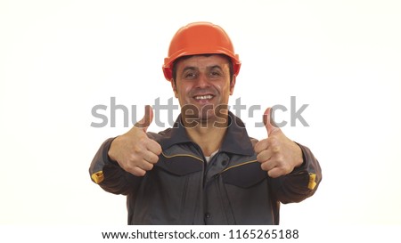 Happy mature Hispanic professional constructionist in uniform and hardhat smiling showing thumbs up positive experience success building industry worker safety profession engineer. Royalty-Free Stock Photo #1165265188